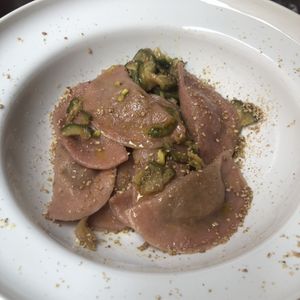 Mezzelune stuffed with potato and pesto with courgette and pistachio crumb  at UNO Caffé Olistico in Bologna