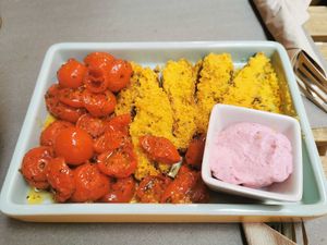 Tomatoes and stuffed zucchini, plus vegan mayo at UNO Caffé Olistico in Bologna