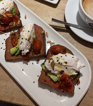 tostada with ricotta, avocado and baked tomato  at UNO Caffé Olistico in Bologna
