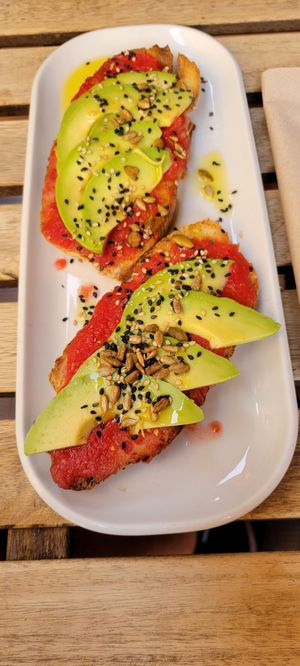 Tostada with fresh tomato and avocado at UNO Caffé Olistico in Bologna