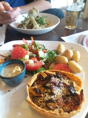 Veggie tart with roast baby potatoes and salad. 
Pasta in background. at Old Plough in Seaford
