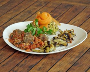 POSEIDON
Homemade vegan Mediterranean meatballs with vegan Puttanesca sauce served with quinoa and carrot pesto, seaweed, capers, eggplant and black Kalamata olives. 
 at Hippocrates Healthy Eatery in Randwick