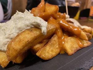 Patatas 3 salsas (cabrales, picante y miel mostaza ) at Cerveceria La Raposa in Oviedo