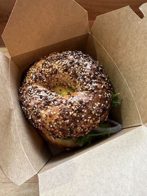 Vegan sausage vegan cheddar arugula everything. Bagel w capers n red onion   at Isaac's Coffee in Salem