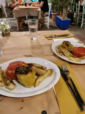 Greek dish, baked bell pepper and tomato filled with rice and served with potatoes. at Mom's Kitchen in Kos