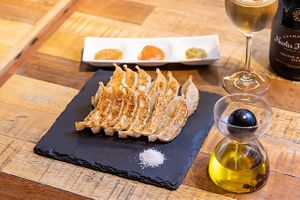 Our vegan gyoza (original or curry taste)that don't use meat or animal fats at all. Please enjoy gyoza with truffle oil & 3 kinds of original gyoza sauce (all Sauce are VG).
 at Champagne & Gyoza Bar in Osaka