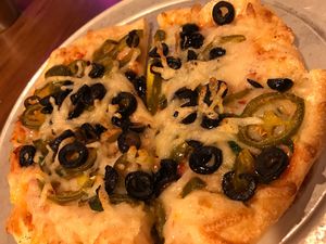 Personal Pan pizza w vegan cheese, black olives, jalapeños and spinach  at Peddlers Pizza Pub in Valparaiso