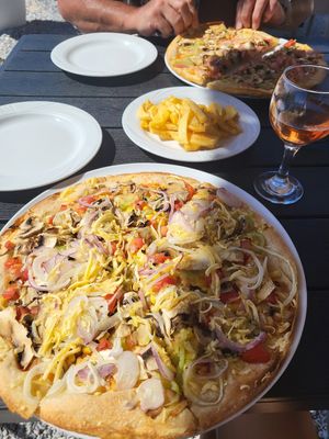 Vegan pizza closest, fries with oregano at Pizza Amici in Thasos