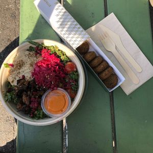 Middle East Salad with falafel, hummus, marinated eggplant, kale, pickled red onion, pomegranate, quinoa and muhamara dip. So fresh and tasty!  at Fafelle in Stockholm