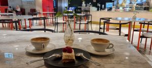 Coconut cake plus two delicious coffees, super happy with this place! at Kafé Plattan in Stockholm