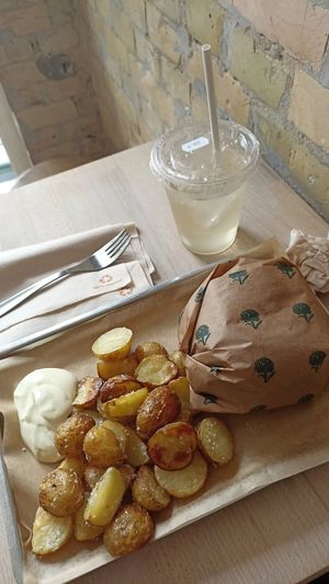 Standard beyond burger with side of baked potatoes and lemonade at Plant Food in Aarhus