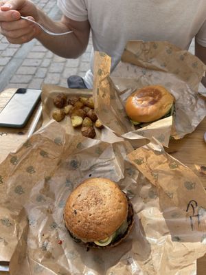 Cheeseburgers (the one in the front with GF bun) plus potatoes  at Plant Food in Aarhus
