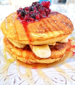Vegan fluffy pancakes with banana, fruits and syrup at The Forest in Oroklini
