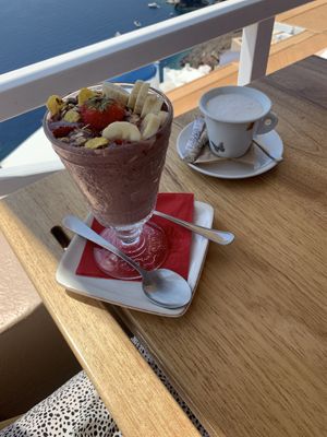 açaí bowl and latte with a view  at Terpsi N Oia in Santorini