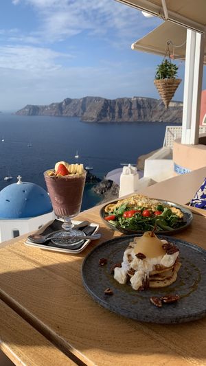 Açaí bowl on the left (only vegan dish on this photo) at Terpsi N Oia in Santorini