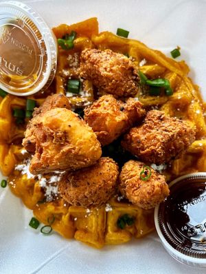 Vegan Chickn and Waffles! Crispy cauliflower chick’n with a sweet potato waffle, served with dipping sauce and maple syrup   at Your Vegan Chef in Dayton