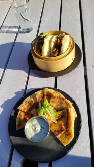 Bao buns (top) and Sour cream & Scallion Pancake (below) at MILA in Vancouver