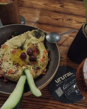 Enormous hummus bowl with deliciously seasoned veggies and warm bread at Vrutal - Poblenou in Barcelona