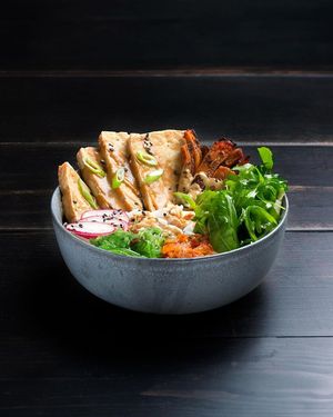 Bibimbap: tamari marinated grilled tofu, steamed rice, satay sauce, rocket, lamb’s lettuce, kimchi, cucumber, carrot, wakame salad and sesame seeds at Vrutal - Poblenou in Barcelona