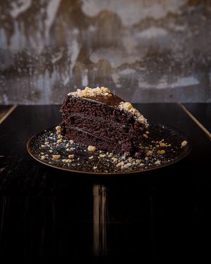 Triple Chocolate Cake: three layers of dutch cocoa cake, chocolate ganache, crunchy hazelnuts and berries coulis at Vrutal - Poblenou in Barcelona
