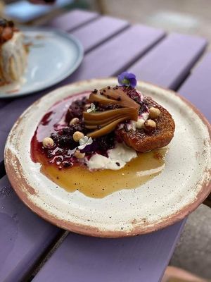 Fancy French Toast with Beetroot Brioche, Poached Pear, Coconut Soya Yogurt, Summer Berry Compote, Hazelnuts & Cocao Nibs at The Nut and Nettle in Bridlington