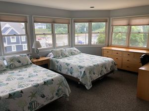 Fishbowl Room has 2 queen beds, excellent views of the river and a door going into the shared bath. at Plant Life Journey Retreats in South Haven