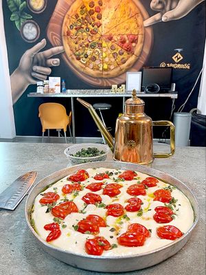 Before baking: Focaccia Barese with olive oil, cherry tomato, fresh oregano. 3 hour notice for this. at Bites7060 in Larnaca