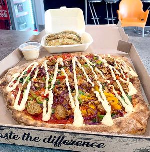 The Beyond sausage pizza with crispy fried and Avocado fries. at Bites7060 in Larnaca