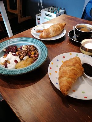 Granola with coconut yoghurt and compote. And a vegan croissant with marmelade. at Hummelbude in Essen