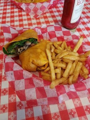 This was the vegan portabello mushroom wrap that came with balsamic glazed mushrooms, spinach, and peppers wrapped in a tortilla - served with deep fried french fries. at Studio Grill in Kalamazoo