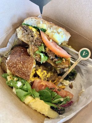 OMG!! Soooo messy but SO GOOD! 😆             Vegan chorizo, polenta ‘egg’, cheddar, mayo with lettuce + tomato on an ‘Old World’ bagel.  at Ghostlight Coffee - Midtown in Dayton