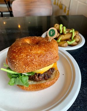 The FAB vegan bagel breakfast sandwich, with a side of smashed potatoes  at Ghostlight Coffee - Midtown in Dayton