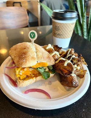 Vegan Frittata brunch sandwich + crispy smashed potatoes with chive aioli + oat milk latte ❤️ #Veganuary at Ghostlight Coffee - Midtown in Dayton