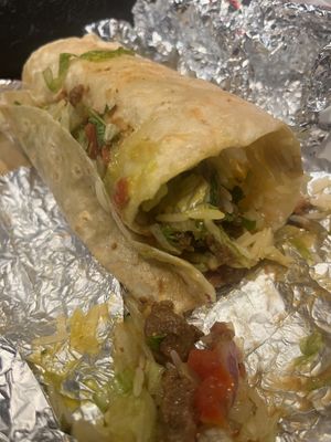 I tried to cut the vegan burrito properly 🫣 It comes very full, and it’s delicious!  at Tortilla House in Helsinki