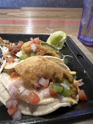 I took the picture when this was half eaten, but this is the fried avocado tacos. I asked for salsa and vegan sour cream on the side, which they happily provided at no extra cost.  at Nacho Daddy in Salt Lake City