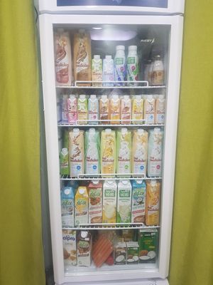 A whole fridge with vegan milk and yogurt! (And vegan sausages on the bottom shelf). at Green Valley in Bishkek