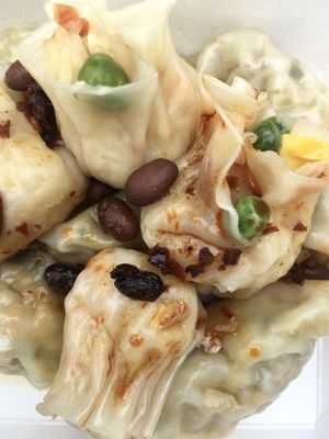 Vegan shao mai and vegan dumplings drenched in their housemade bean chili sauce  at Steamed in Brisbane