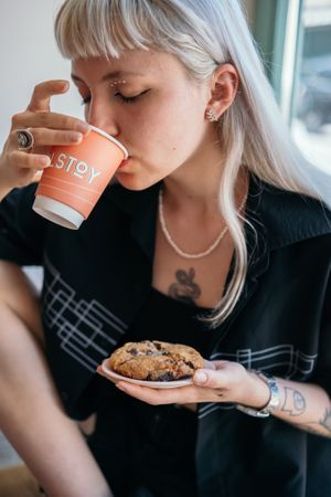 Masha enjoying Tolstoy coffee and a chocolate chip cookie at Tolstoy in Vienna