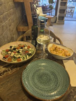 Patatas bravas and Greek salad  at Cinnamon in Sitges