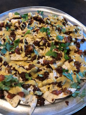 Nachos with Mushroom "Chorizo", our homemade Cashew "Queso", Fresh local cilantro, tomatoes & Onions. at Farm To Fork in Bigfork