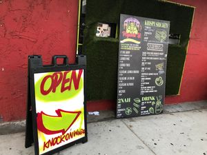 The view from the street.  The little window that you knock on is to the left of the outside menu. at VegainzLA - La Brea in Inglewood