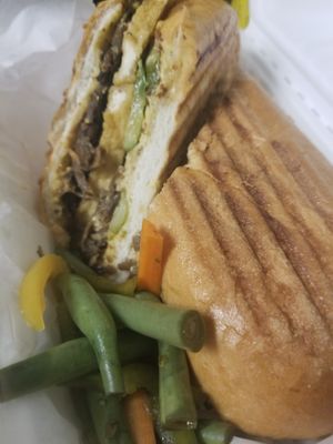 Tofubano sandwich - crispy fried tofu, pulled mushroom stems, house pickled vegetables, and whole grain mustard pressed on a hoagie roll (all vegan) at Wonderland in Milwaukee