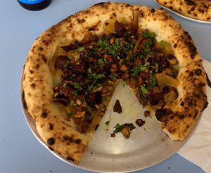 Vegan Pizza: caramelized onions, roasted mushrooms, walnut and raising vinaigrette, mint and lemon zest.  at Lupita Pizzaria in Lisbon