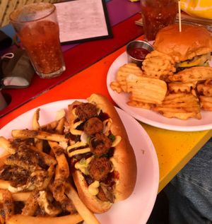 Herbs hotdog with garlic cream cheese, bbq sauce and amazing fried jalapeños with a poutine upgrade and the bacon cheese impossible burger with waffle fries  at Bad Apple  in Vancouver