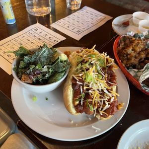 Chili Cheese Dog with side caeser salad  at Bad Apple  in Vancouver