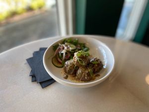 Vegan & GF Thai “Impossible” Meatballs with peanut sauce. Served with a simple cucumber & onion salad.  at Cyth & Co in Oakland Park