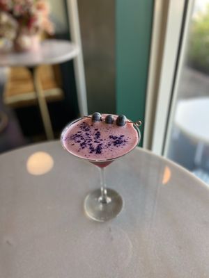 The “Blotto” Cocktail: vodka, lemon, or flower, basil, glitter.  at Cyth & Co in Oakland Park