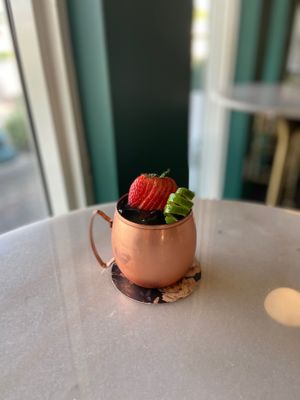 The “Two-Bit” Cocktail: cognac, citrus, strawberry, rosemary, agave, matcha, orange bitters.  at Cyth & Co in Oakland Park