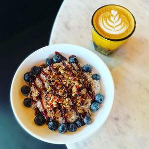 Housemade Chia Pudding with fresh blueberries, housemade granola, and raspberry jam drizzle. Served with an oat milk cortado.  at Cyth & Co in Oakland Park