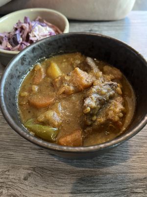 Goat curry and a side of slaw  at Jam Delish in North London